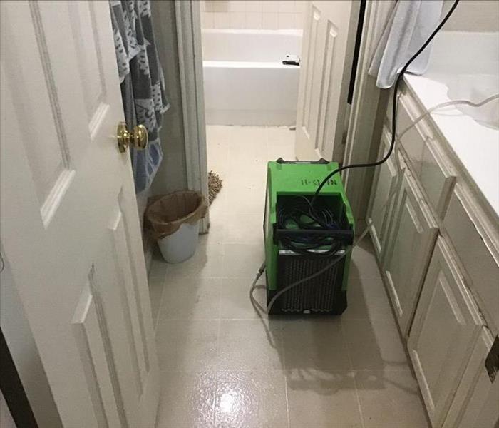 flooded bathtub in bathroom